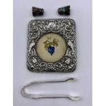 A mixed selection of silver items to include frame front, thimbles, small tongs etc.