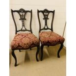 A Pair of Mahogany dining chairs with pierced splats.