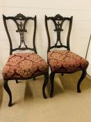 A Pair of Mahogany dining chairs with pierced splats.