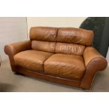 A two seater tan Italian leather sofa by Sofaitalia