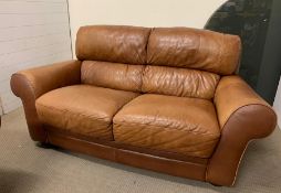 A two seater tan Italian leather sofa by Sofaitalia