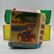 Three boxed clockwork/wind-up tin toys