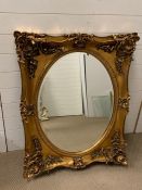 A gilt frame wall mirror with oval shape glass (87cm x 106cm)