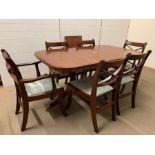 A mahogany dining table on turned legs ending on brass claw feet with four chairs and two carvers (