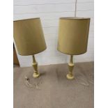 A pair of tall turned wood lamps