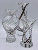 A selection of three Caithness encased glass vases