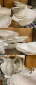 A large collection of white cookware and serving dishes