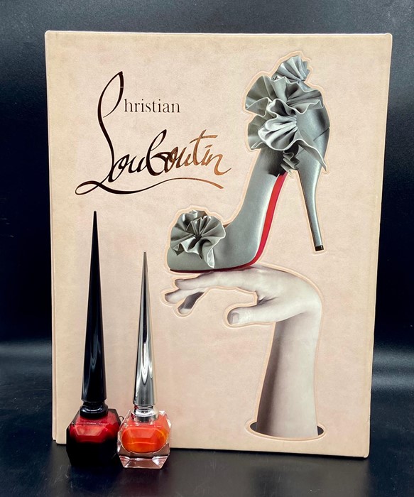 A large Christian Louboutin reference book by Rizzoli New York with two collectable Louboutin Beauty