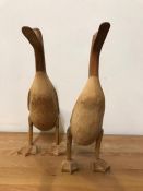A pair of carved wooden ducks