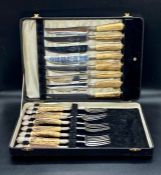 A Harrison Fisher Trafalgar design stainless steel knife and fork set, boxed Sheffield