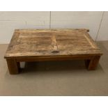 An oak coffee table made in Mexico, possibly made from an old door (H45cm W160cm D88cm)