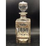 A decorative decanter with white metal frame work to outside