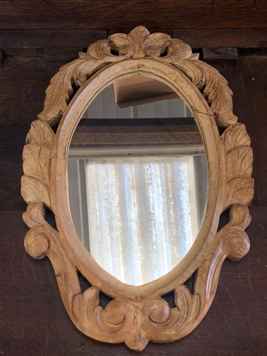 A small carved wooden framed mirror (46cm x 30cm)
