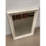A white framed and carved mirror (H90cm W62cm)