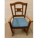 A teak child's rocking chair