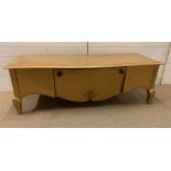 A low media unit/table on cabriole legs and scrolled detail to front (H53cm W157cm D55cm)