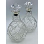 A Pair of silver collared (1964) crystal decanters.