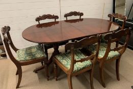 A mahogany dining table on twin pedestal base and six chairs