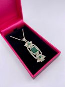 A silver necklace set with marcasite and jadeite panel.