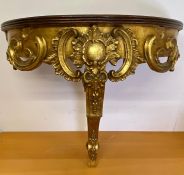 A gilt and mahogany wall mounted console table