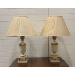 A pair of white and gilt table lamps with swags and foliage