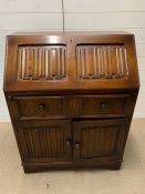 An oak bureau with linen fold front (H100cm W77cm)