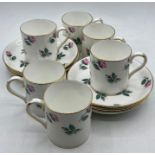 A set of six floral decorated Crown Staffordshire Coffee Cans and Saucers