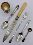 A selection of silver items to include an egg cup and spoons, etc.