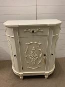A white side cabinet with hinged doors to front and sides with carved detailing (H90cm W80cm D40cm)