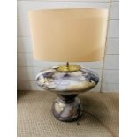 A mottled design table lamp with cream shade