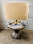 A mottled design table lamp with cream shade