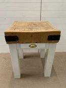A vintage butchers block on white painted legs and drawer
