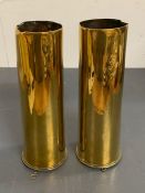A pair of brass shell cases