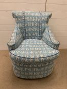 A bedroom chair with alphabet fabric upholstery