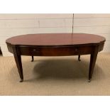 A mahogany coffee table of an oval shape with inlay and drawers to sides (H45cm W107cm D56cm)