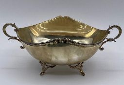 A silver two handled bowl on four legs, marked 830. Total weight 103g.