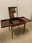 A mahogany gentleman's dressing table, hinged lid opening to a fitted interior in moving divisions