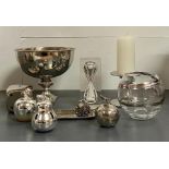 A selection of decorative objects including candle holders, vases and a chrome/silver effect bowl on