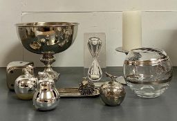 A selection of decorative objects including candle holders, vases and a chrome/silver effect bowl on