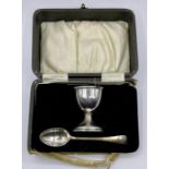 A silver egg cup and spoon (box AF) by A L Davenport Limited, hallmarked for Birmingham 1930.