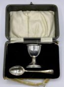 A silver egg cup and spoon (box AF) by A L Davenport Limited, hallmarked for Birmingham 1930.