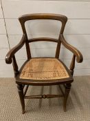 A Children's mahogany chair with cane seat (H65cm)