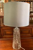 A cut glass table lamp with grey shade