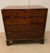 A four drawer mahogany chest of drawers on bracket feet and brass drop handles (H87cm W85cm D49cm)