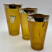 A set of three graduated silver rimmed beakers AF with a London hallmark.