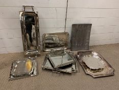 A large selection of silver plate and white metal inter design display trays, eleven trays in