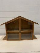 A small display case in the form of a house (H44cm W64cm)
