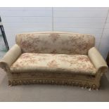 A three seater sofa with tapestry style fabric upholstery and tassel edging (H90cm W210cm D86cm)