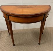 A George III satinwood and marquetry demi lune gaming table (grinning top) on square tapering