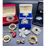 A selection of costume jewellery brooches.
